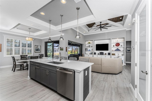 kitchen with dishwasher, an island with sink, light hardwood / wood-style floors, ceiling fan, and decorative light fixtures