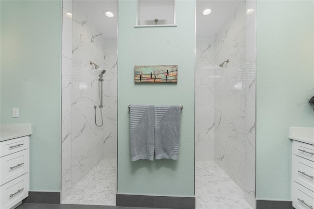 bathroom featuring vanity and tiled shower