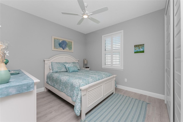 bedroom featuring a closet, light wood-type flooring, and ceiling fan