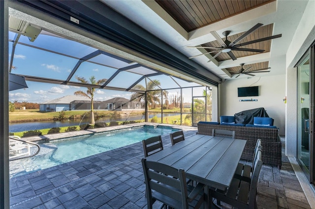 view of pool featuring a patio, pool water feature, a water view, glass enclosure, and ceiling fan