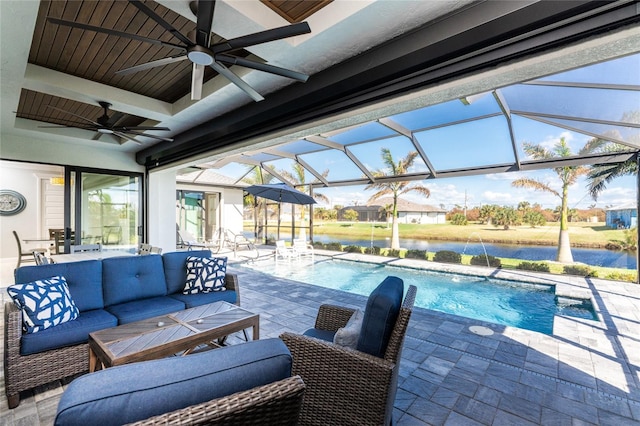 view of swimming pool with glass enclosure, ceiling fan, pool water feature, a patio area, and outdoor lounge area