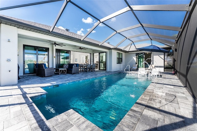 view of pool featuring an outdoor hangout area, ceiling fan, pool water feature, a lanai, and a patio area