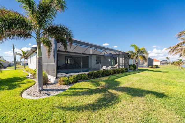 rear view of property featuring a pool, a lawn, and glass enclosure