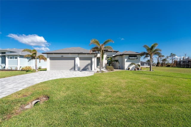 view of front of home with a front lawn and a garage