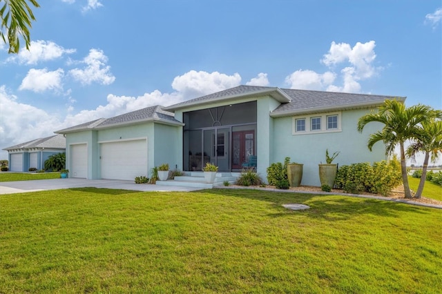 ranch-style house featuring a front lawn and a garage