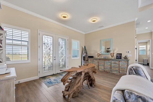 interior space with french doors, hardwood / wood-style flooring, and crown molding