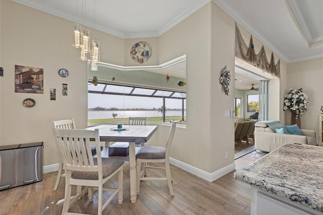 dining room featuring ornamental molding, ceiling fan with notable chandelier, and light hardwood / wood-style floors