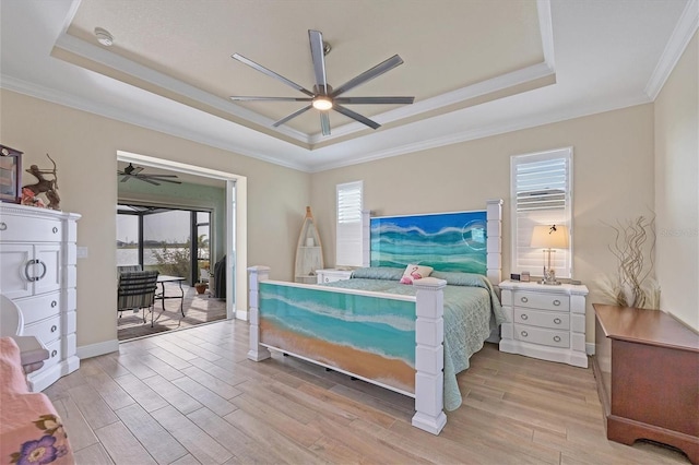 bedroom featuring access to outside, crown molding, light wood-type flooring, a raised ceiling, and ceiling fan