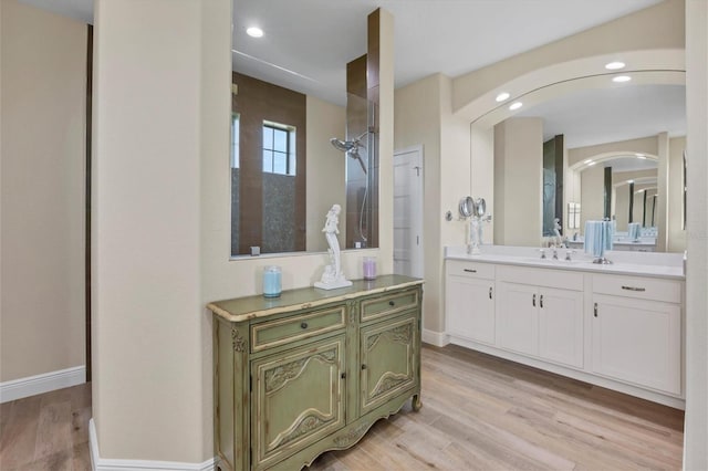 bathroom with vanity, walk in shower, and hardwood / wood-style flooring