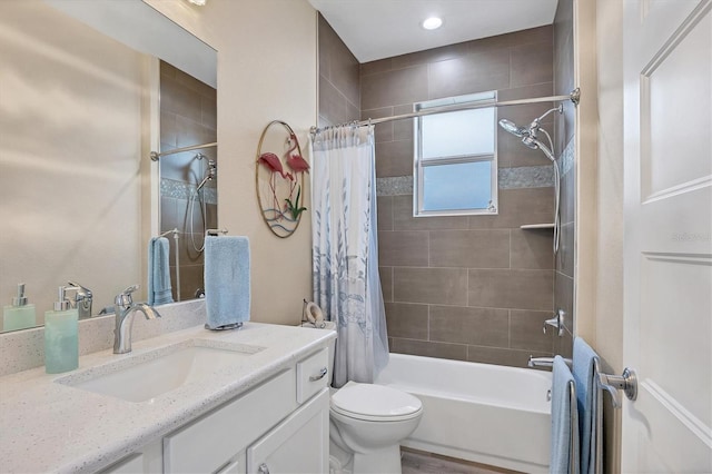 full bathroom featuring vanity, hardwood / wood-style floors, shower / bath combo, and toilet