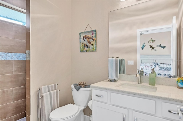 bathroom featuring vanity, toilet, and radiator