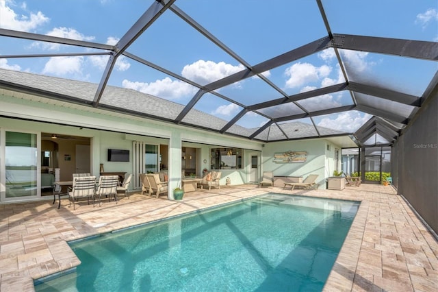 view of swimming pool with a patio area and glass enclosure