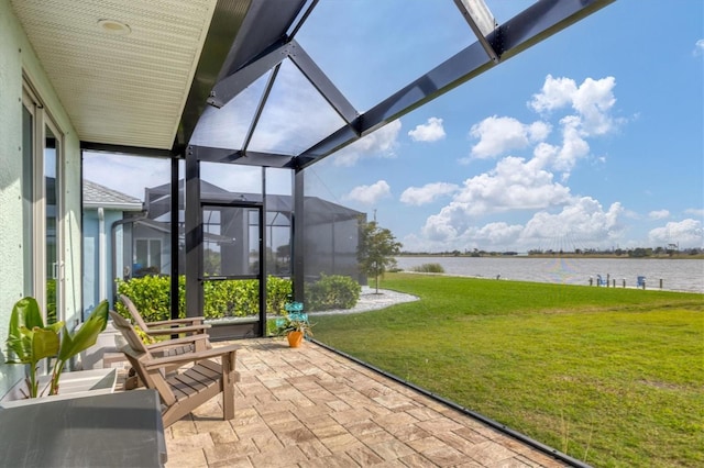 view of patio with a lanai and a water view