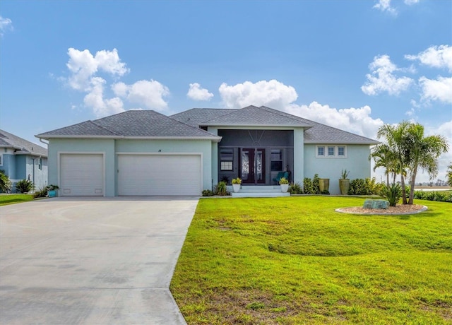 prairie-style home with a front yard and a garage