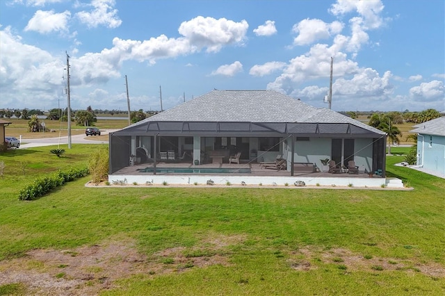 rear view of house with a yard, a patio, and glass enclosure