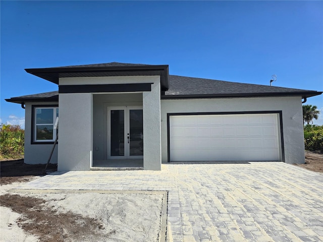 view of front of house with a garage and french doors