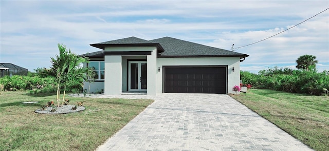 view of front facade featuring french doors, a garage, and a front lawn