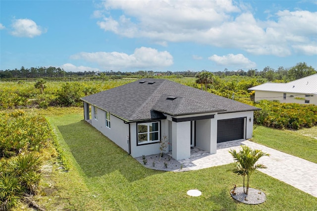 view of front of home featuring a garage and a front lawn