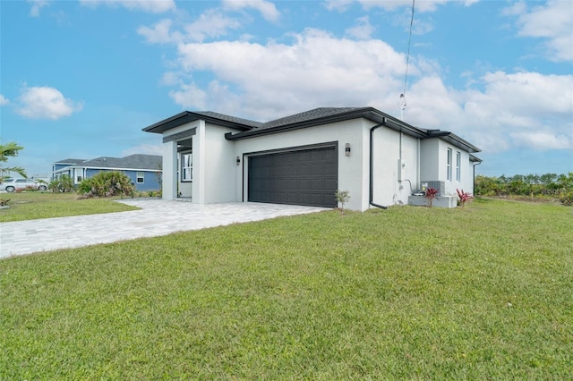 view of side of home featuring a garage, cooling unit, and a lawn