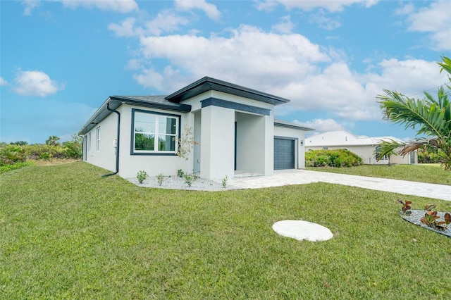 view of front of property with a garage and a front yard