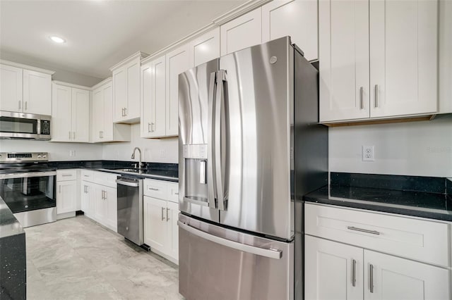 kitchen featuring white cabinetry, appliances with stainless steel finishes, and sink