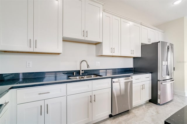 kitchen featuring stainless steel appliances, sink, and white cabinets