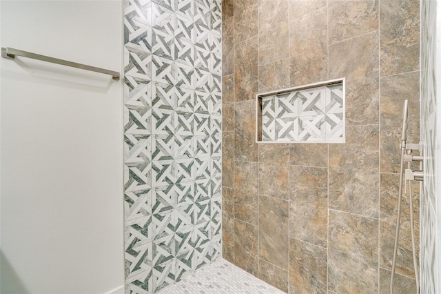 bathroom with a tile shower