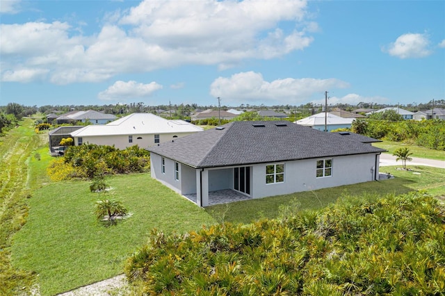 rear view of house with a lanai and a lawn