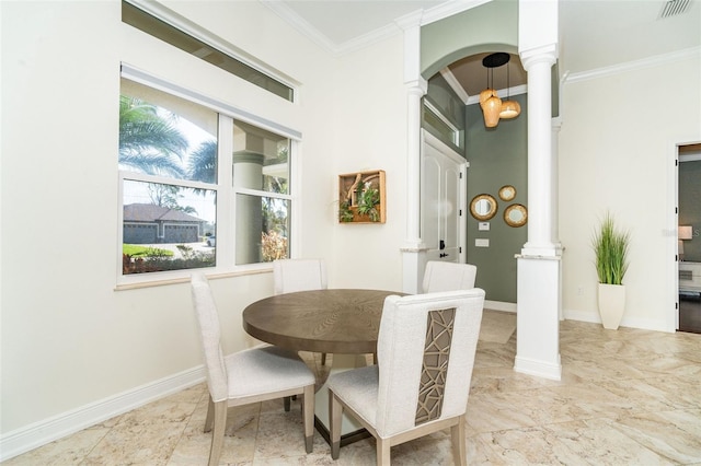 dining area featuring ornamental molding and ornate columns