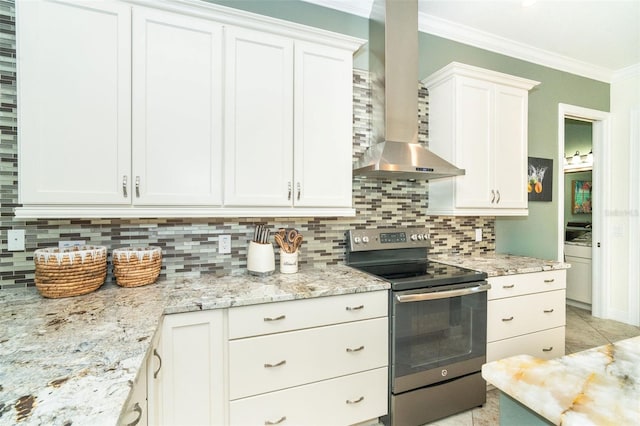 kitchen featuring white cabinetry, tasteful backsplash, ornamental molding, stainless steel electric range oven, and wall chimney exhaust hood