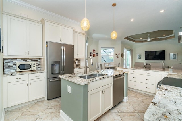 kitchen featuring pendant lighting, sink, white cabinetry, and stainless steel appliances