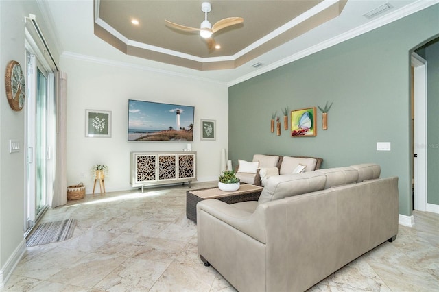 living room with crown molding, ceiling fan, and a raised ceiling