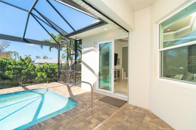 view of swimming pool featuring a lanai and a patio