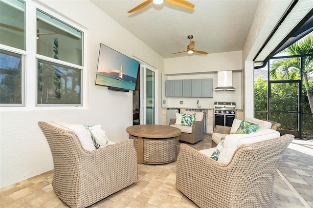 view of patio / terrace featuring an outdoor living space, a lanai, ceiling fan, and exterior kitchen