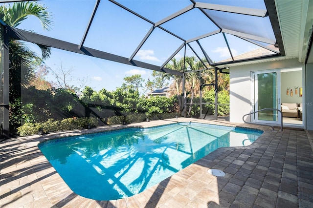 view of pool with a patio and glass enclosure