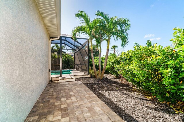 view of patio featuring a lanai