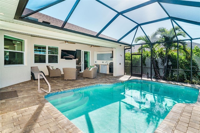 view of swimming pool featuring an outdoor hangout area, a patio area, ceiling fan, and glass enclosure