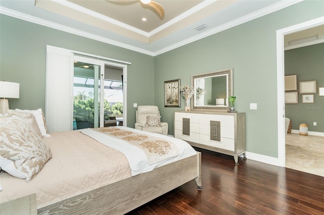 bedroom featuring crown molding, dark hardwood / wood-style floors, and a raised ceiling