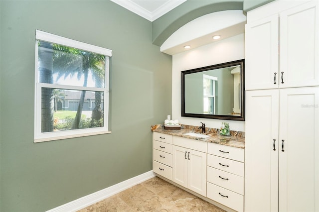 bathroom with ornamental molding and vanity