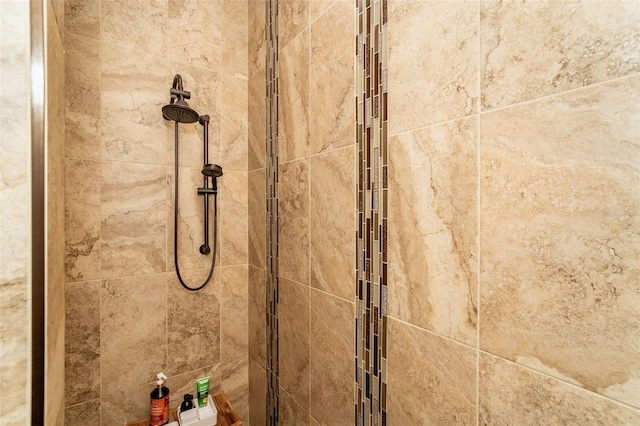 interior details with a tile shower