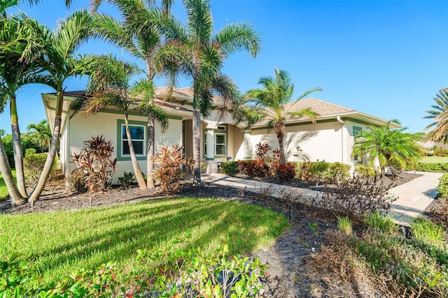 mediterranean / spanish house featuring a front yard