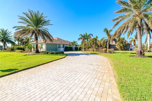 view of front of house with a garage and a front yard