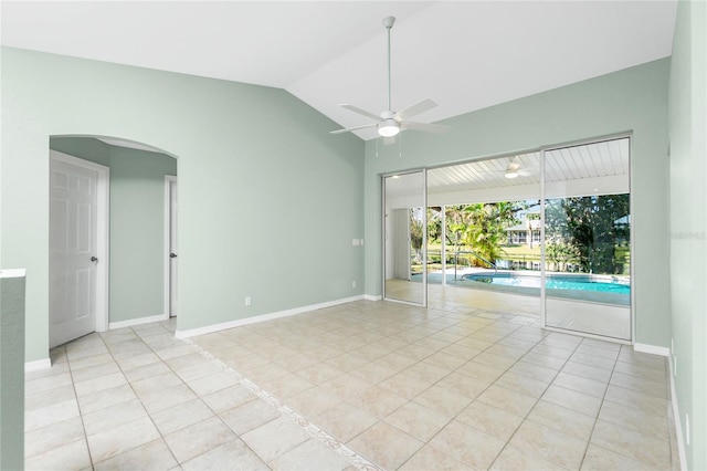 tiled spare room featuring ceiling fan and vaulted ceiling