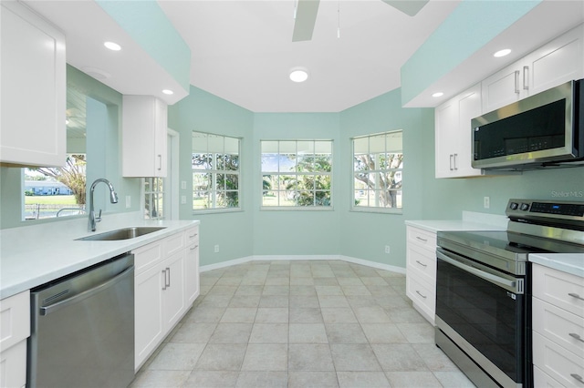 kitchen featuring a wealth of natural light, sink, white cabinets, and stainless steel appliances