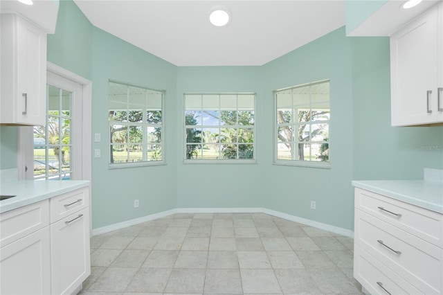 unfurnished dining area featuring light tile patterned flooring and a healthy amount of sunlight