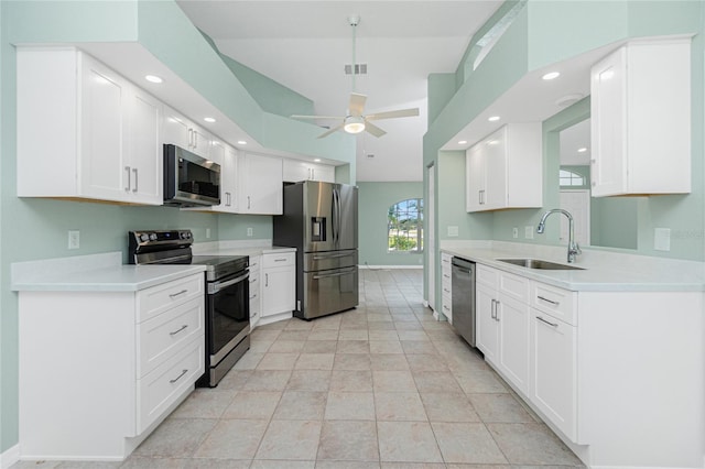 kitchen with stainless steel appliances, ceiling fan, sink, white cabinetry, and light tile patterned flooring