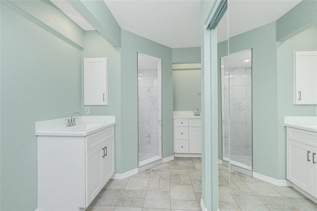 bathroom featuring tiled shower and vanity