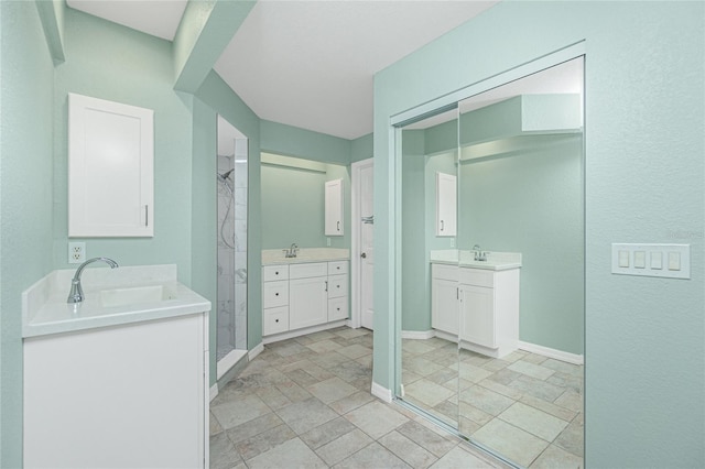 bathroom featuring a shower and vanity