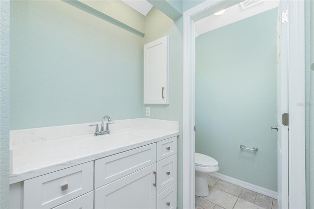 bathroom featuring tile patterned floors, vanity, and toilet