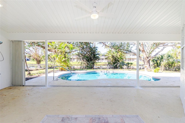 view of pool with ceiling fan and a patio